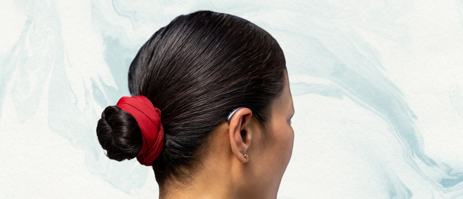 Middle-aged woman touching her ear, showing concern—highlighting hearing loss linked to hormonal changes in women over 40.